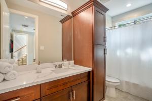 a bathroom with a sink and a toilet and a mirror at Spacious 3 Bed House near MD Anderson with Free Parking & Wi-Fi in Houston
