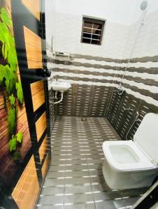 a bathroom with a toilet and a sink at Enna homestay in Varkala