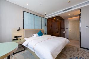 Postelja oz. postelje v sobi nastanitve Warm Yes Business Hotel -Free shuttle bus during the Canton Fair
