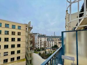 a balcony with a view of a city at Lavie Maison : A C & Eiffel Tower View in Paris