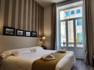 Postel nebo postele na pokoji v ubytování Hotel San Lorenzo Boutique + 126 fotografií