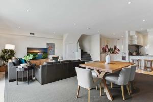 a living room with a table and a couch at Spacious 3-Bed Apartment by the MCG in Melbourne