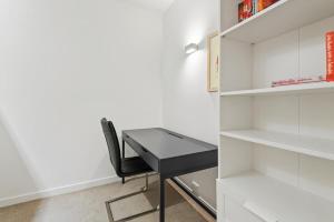 a black desk in a white closet at Beautiful 1-Bed Unit in The Heart of Melbourne in Melbourne