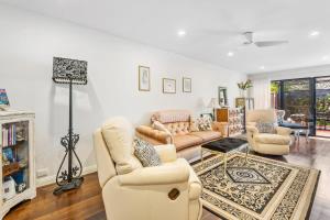 a living room with two couches and a table at Delightful 2-Bed Townhouse Close to the Beach in Frankston