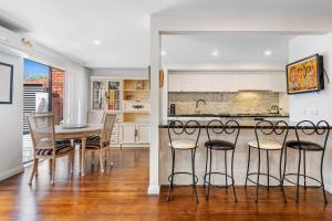 a kitchen and dining room with a table and chairs at Delightful 2-Bed Townhouse Close to the Beach in Frankston