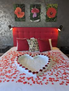 a bed with a heart made out of red flowers at Sea Holly Gozo in Nadur