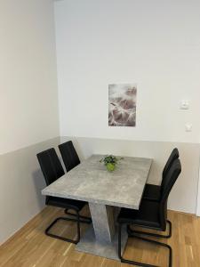 a dining room table with two chairs and a marble table at Paky Appartements 00209 in Vienna