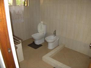 uma casa de banho com um WC e um bidé em Rosemary's Guesthouse em Praslin