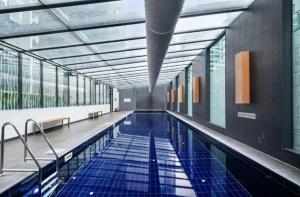 una piscina con azulejos azules en un edificio en Southbank Central 2-Bed - Pool, Gym & City Views, en Melbourne