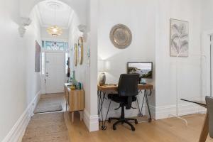an office with a desk and a chair in a room at Refined 2-Bed House with a Charming Courtyard in Melbourne