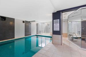 a swimming pool in a building with a sign next to it at Lovely Boutique 1-Bed Unit with Gym & Pool in Melbourne