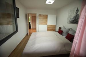 a bedroom with a large white bed in it at Alpenblume in Imst