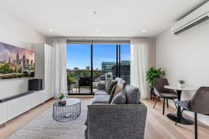 a living room with a couch and a large window at Great Richmond 1-bed Conveniently Located By Shops in Melbourne