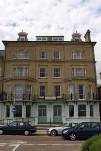 a large building with cars parked in front of it at The Clyffe Hotel in Lowestoft