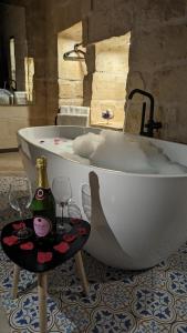 a bath tub with two glasses and a bottle of champagne at Sea Holly Gozo in Nadur