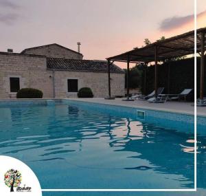 a large swimming pool in front of a house at Tre Balate Natura e Relax in Modica