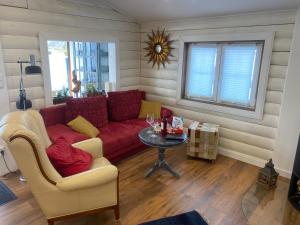 a living room with a red couch and a table at Ferienhaus“Wieden am See“ in Sievern