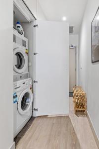 a laundry room with a washer and dryer at Sophisticated CBD 2-Bed Apartment by Yarra River in Melbourne