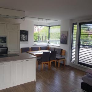 a kitchen and dining room with a table and chairs at Penthouse in den Bergen in Imst