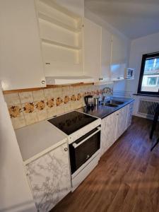 a kitchen with a sink and a stove top oven at Lugn och skön lägenhet centralt. in Gothenburg