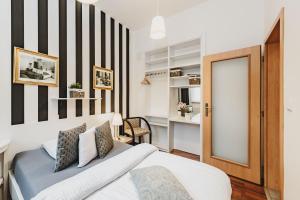 a bedroom with a bed and a black and white stripe wall at Grand Tábor in Tábor