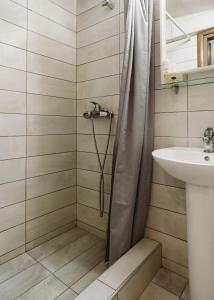 a bathroom with a shower and a sink at Lef Apartment in Thessaloniki