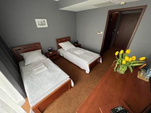Posteľ alebo postele v izbe v ubytovaní OLIMPIA Ośrodek Przygotowań Sportowych