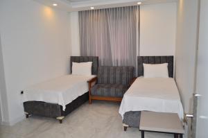 Postel nebo postele na pokoji v ubytování Akdeniz Yaşam Otel