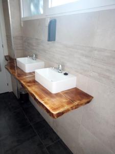 a bathroom with two sinks on a wooden counter at Dreams Low Cost in Madrid