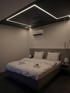 a bedroom with a large bed with lights on it at Swan in Belgrade
