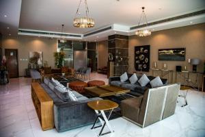 uma grande sala de estar com sofás e mesas em Ginger Luxury House em Juffair