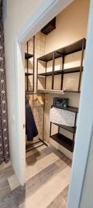 a room with a closet with shelves and a hallway at LOFT DELUXE - MADRID RETIRO in Madrid
