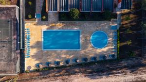 an overhead view of a swimming pool with two windows at Kampaoh Vagueira in Palheiros da Vagueira