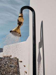 a broom being used to clean a wall at The Wild by Interni in Kalafatis +37 photos