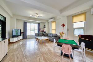 a living room with a ping pong table at 旅居Villa in Dongshan