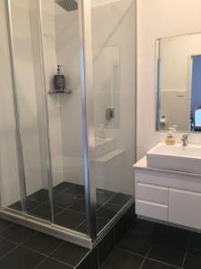 a bathroom with a shower and a sink at Urban Warehouse in Queanbeyan