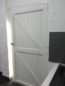 a white garage door with a window and a door at Urban Warehouse in Queanbeyan