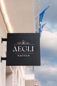 a sign for aell studios hanging on a building at Aegli Suites in Levádeia