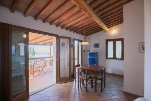 a dining room with a table and a balcony at Appartamenti Mandorlo e Melograno by HelloElba in La Guardia