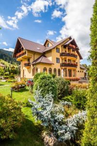 a large house with a garden in front of it at Dor de Munte in Sadova