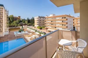 a balcony with a view of a pool and buildings at htop Amatista #htopBliss in Lloret de Mar