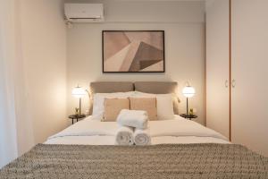 アテネにあるChic and Lavish Apartment in Athensのベッドルーム1室(大型ベッド1台、タオル2枚付)