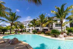 a resort with a swimming pool and palm trees at Star of Caribbean- Estrella Dominicus Bayahibe in Bayahibe