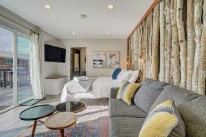 a living room with a couch and a table at PeakView Lil Lux - Prime Spot King Hot Tub Views in Colorado Springs