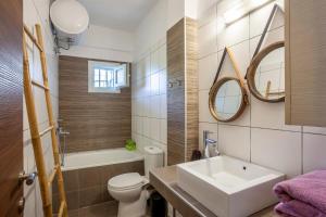 a bathroom with a sink and a toilet and a tub at The Garden Villa Hanioti in Hanioti +51 photos