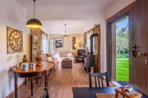 a living room with a table and a couch at The Garden Villa Hanioti in Hanioti