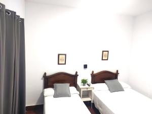 Posteľ alebo postele v izbe v ubytovaní Hostal Cuzco
