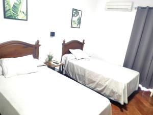 Posteľ alebo postele v izbe v ubytovaní Hostal Cuzco