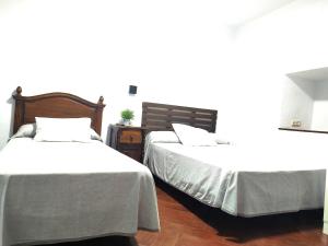Posteľ alebo postele v izbe v ubytovaní Hostal Cuzco