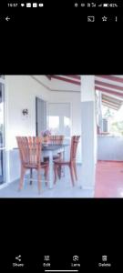 a dining room table with two chairs and a table with at Blue Moon Villa in Waskaduwa
